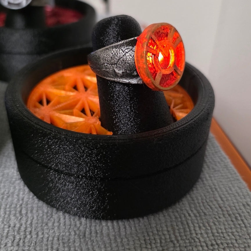 Orange Lantern physical ring and display stand, square side-angle photograph