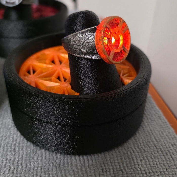 Orange Lantern physical ring and display stand, square side-angle photograph