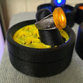 Yellow Lantern physical ring and display stand, square side-angle photograph
