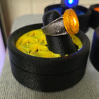 Yellow Lantern physical ring and display stand, square side-angle photograph
